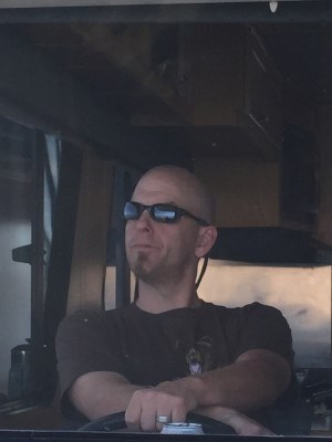 Man steering a houseboat.