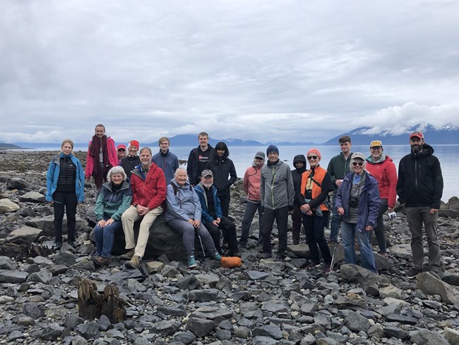 A group of people gather on a northern beach.