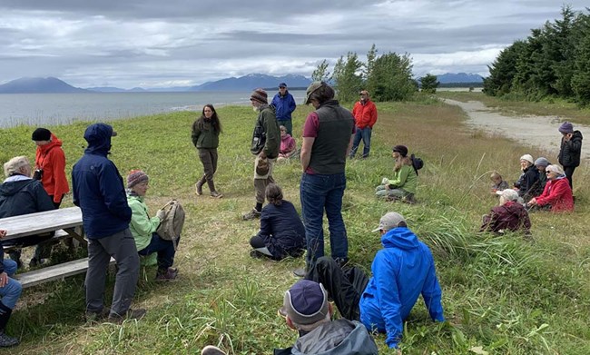 A group of people listen to an NPS scientist.