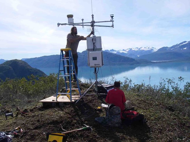 Researchers install a weather station above Queen Inlet, Glacier Bay.