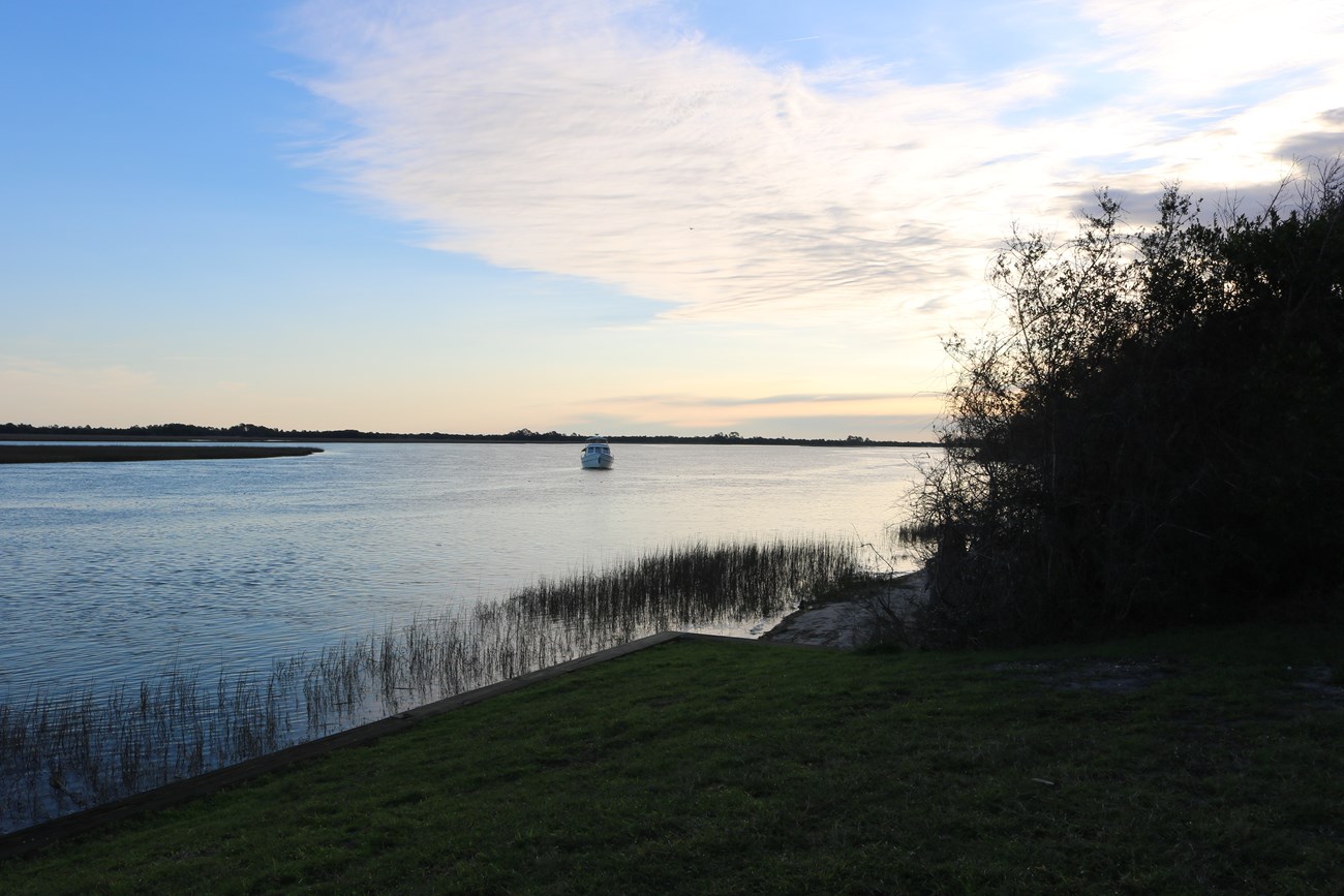 Boat in the middle of the Fort George River at the Ribault Club.