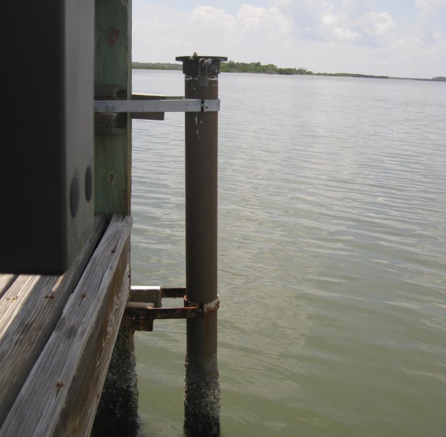 Monitoring station at Visitor Center dock at CANA. Dock with a pvc holder attached on the right side