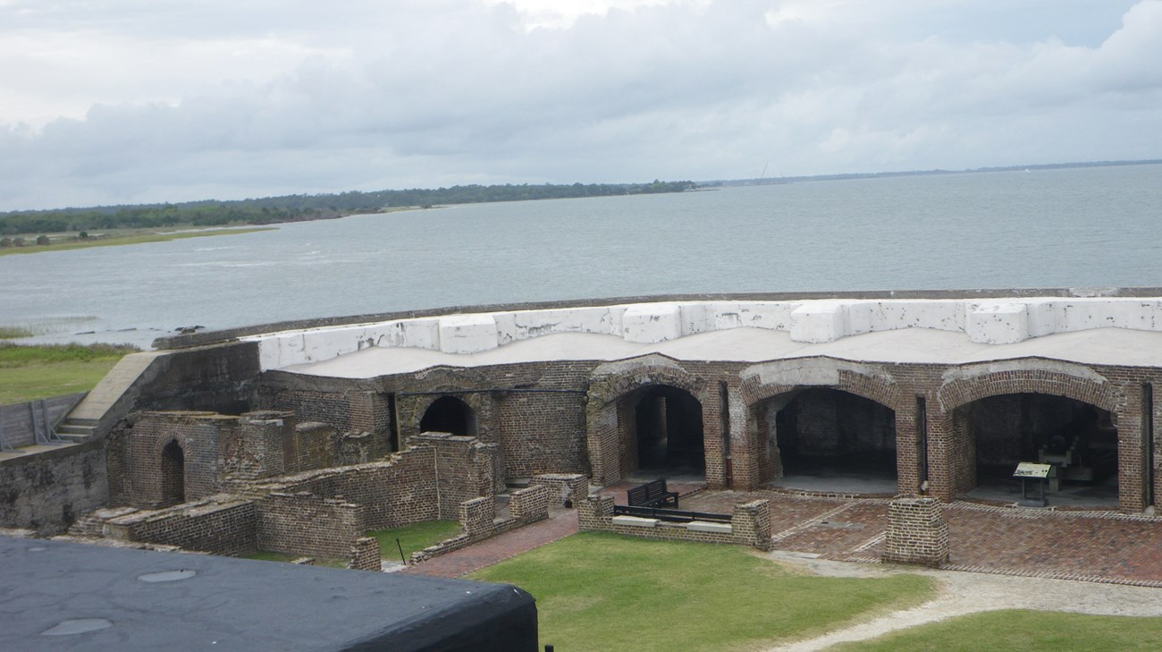 Looking at the inside wall of a fort with the water in the background