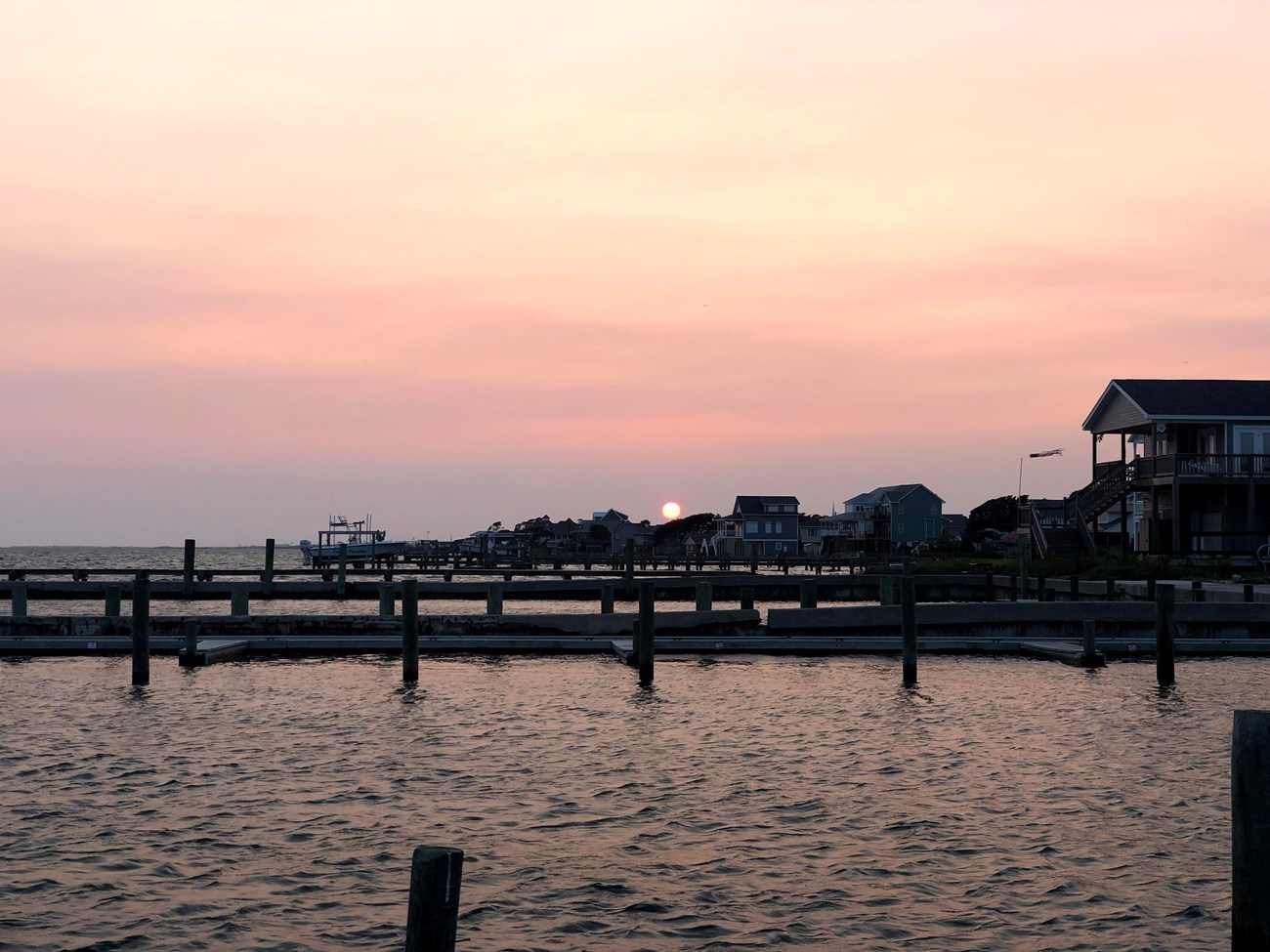 Sunset at CALO String of docks down a waterway at sunset