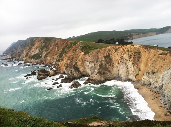 Elephant seals on beach below Chimney Rock overlook cliffs