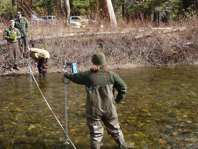 Scientist in hip waders takes depth measurements in the Middle Fork of the San Joaquin River, Devils Postpile National Monument.