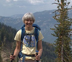 Linda Mutch hiking in Sequoia National Park photo of woman with hiking poles and daypack, views of mountains in background