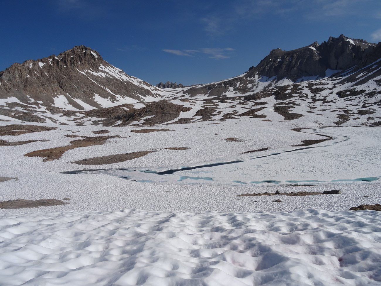 Late-lying snow lingers over Lake South America, surrounded by rugged peaks, Sequoia National Park. Photo by Mandy Holmgren