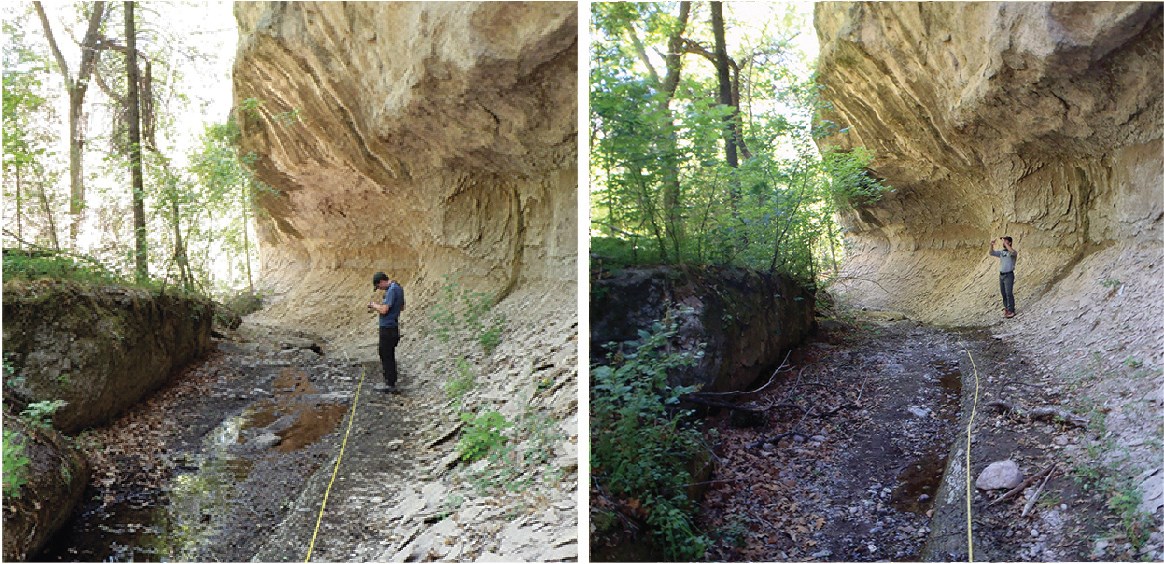 Person stands in depression between a canyon wall and stream bank. Ground is wet.