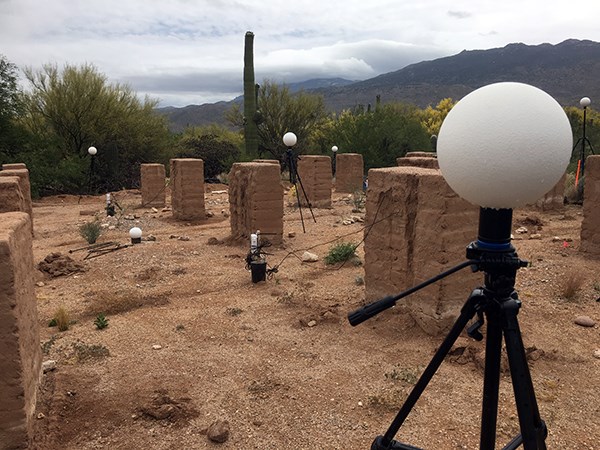 Reference points White globes sit on tripods among adobe walls in rows