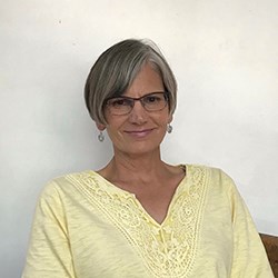 A woman sitting facing the camera