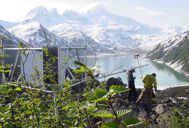 Researchers set up a remote, high-elevation climate station.