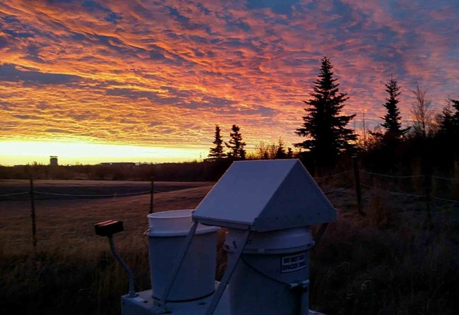The air quality monitoring station with sunrise in the background.