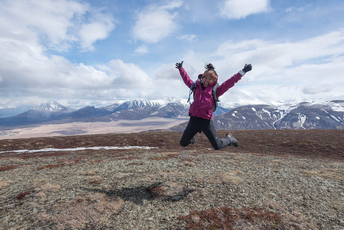 A woman jumps for joy