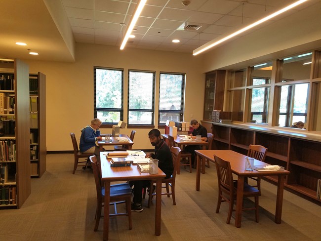 Researchers at work at the Collections Preservation Center.