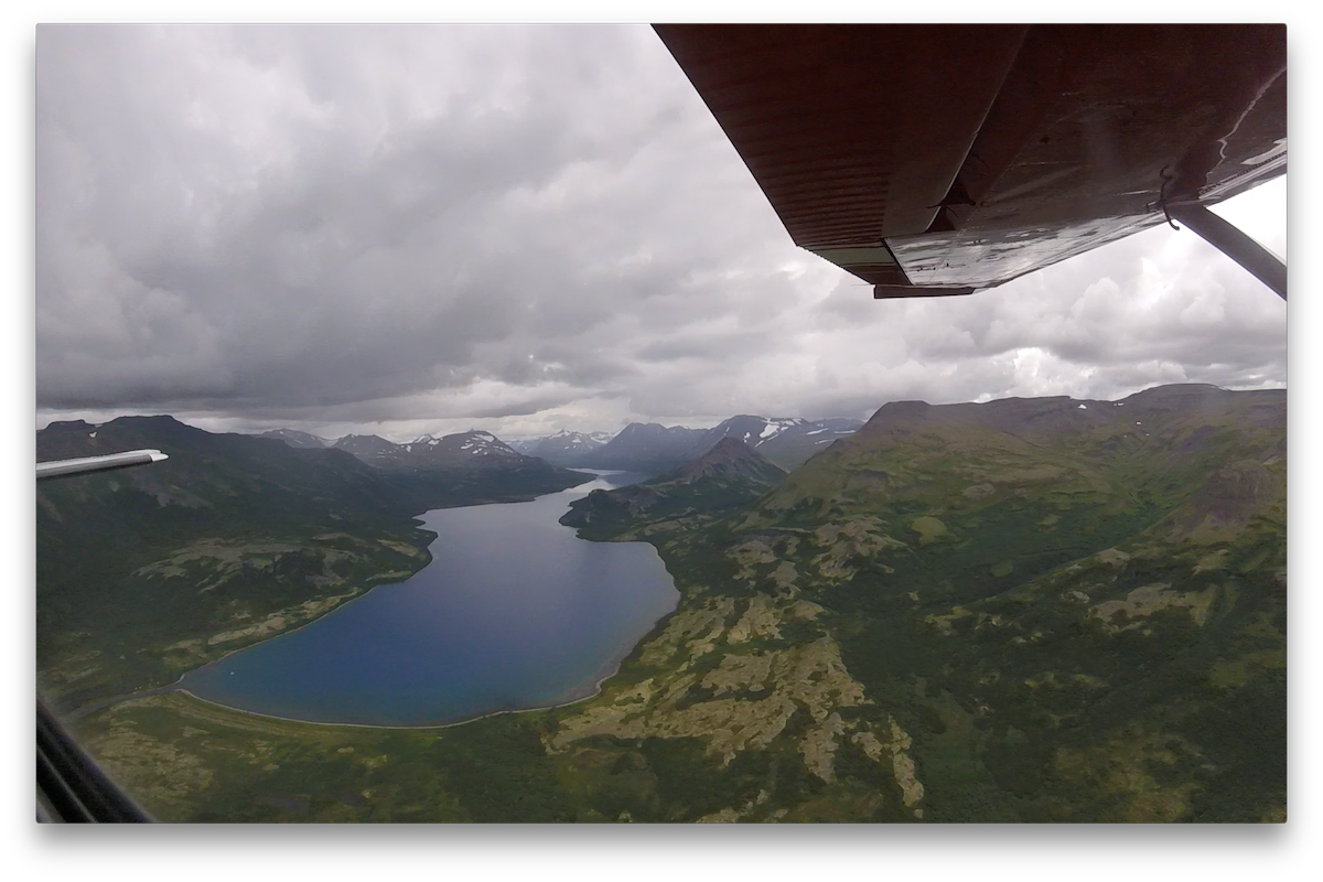 Aerial view of a lake and mountains on a cloudy day