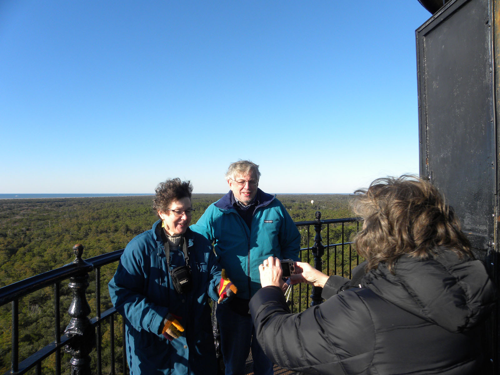 A volunteer takes photos of visitors at Cape Hatteras Lighthouse