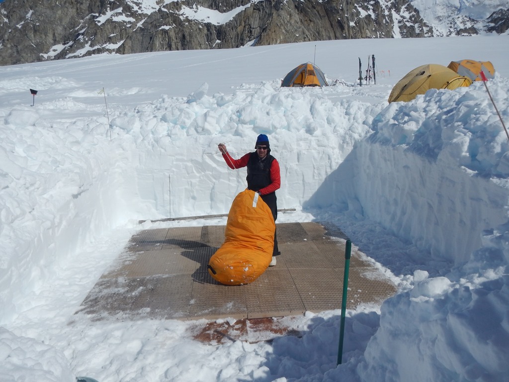 A volunteer gets ready to construct a tent