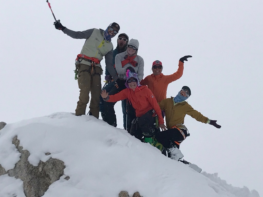 Edge of the World Six patrol members pose on a snowy rock outcropping