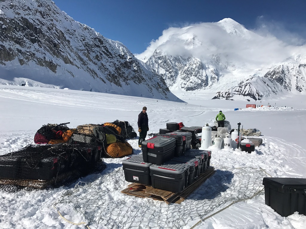 Ferrying loads from Basecamp A stack of gear and action packers sit on a glacier waiting to get ferried to 14,200 feet