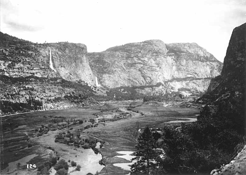 Hetch Hetchy Valley: high mountain peaks border fertile valley with river flowing through