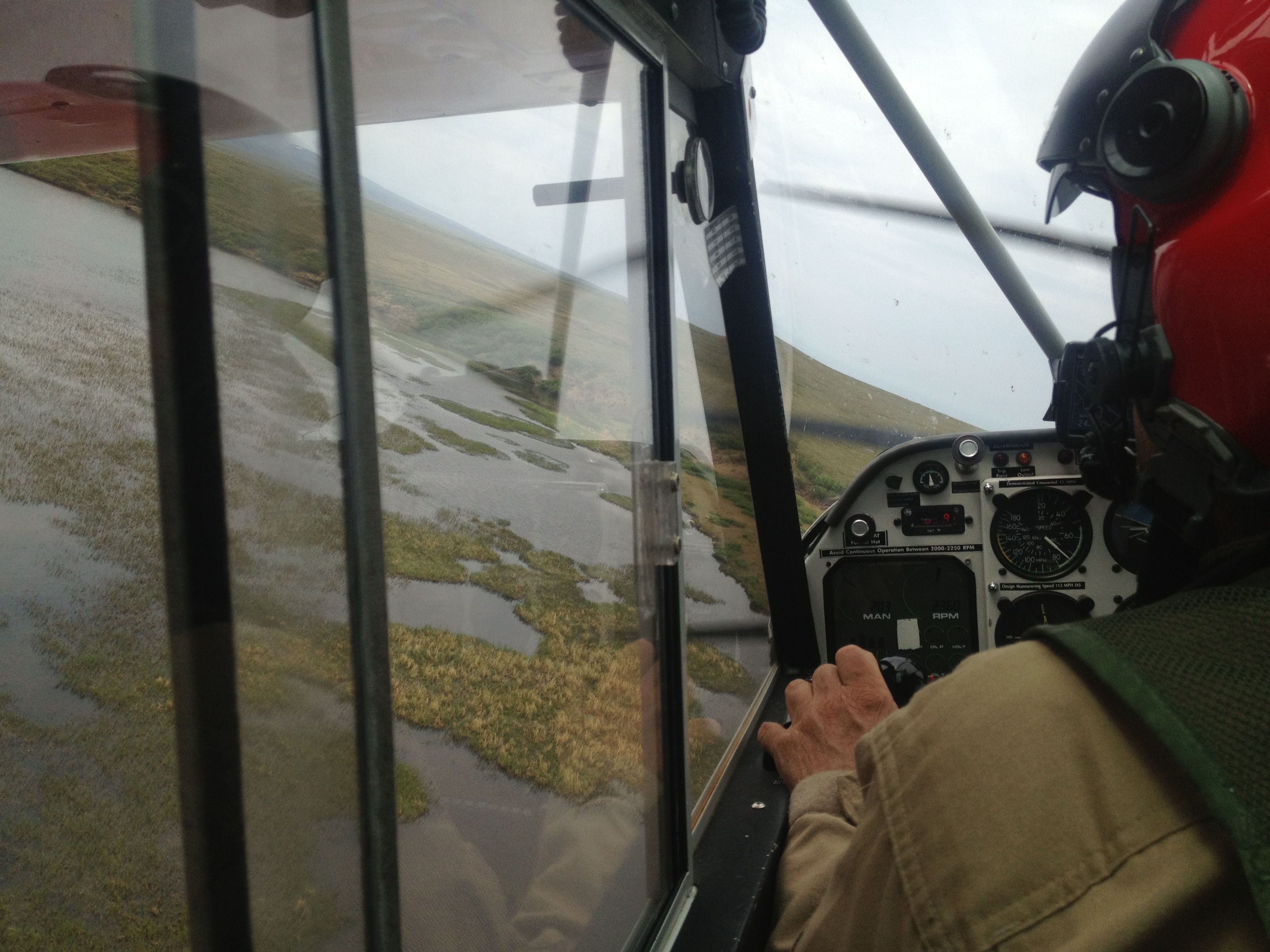 Conducting aerial surveys A view from the cockpit of a small plane as the pilot swerves his aircraft in search of loons nesting in marshes in Bering Land Bridge National Preserve.