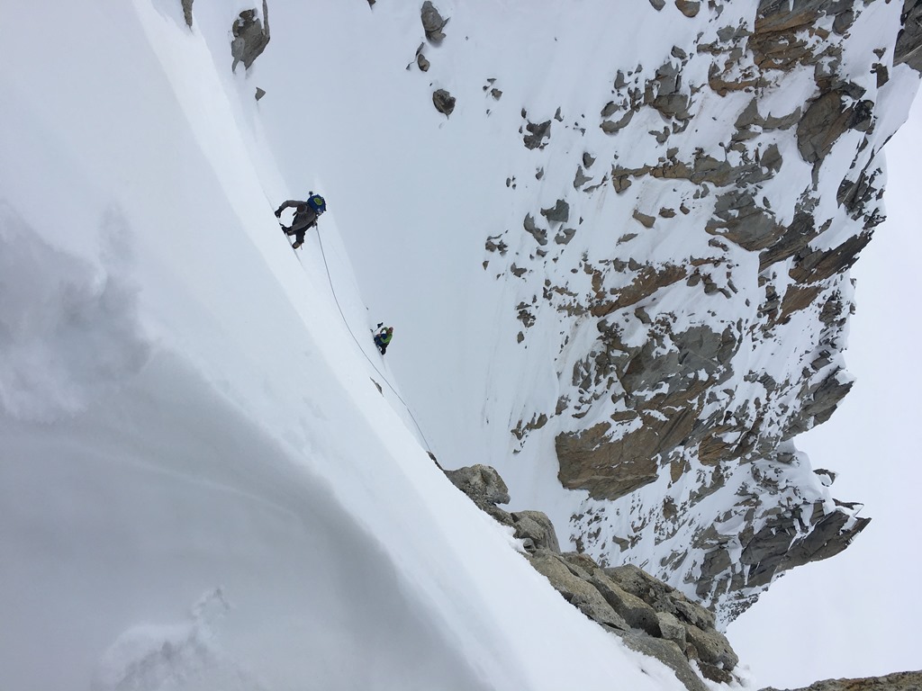 Access couloir to Annie's Ridge Two roped climbers ascend a steep snow ridge