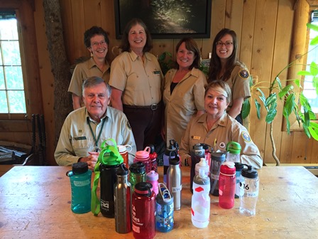 Lost and Found volunteers with just a few water bottles found during summer 2016. (NPS Photo) Six volunteers stand with colorful water bottles.