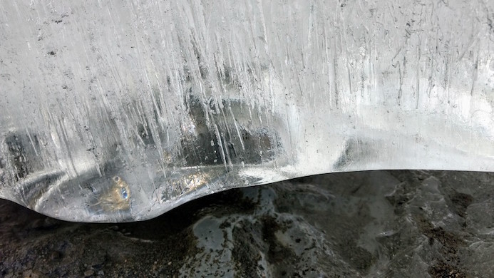A thick slab of ice with columned pockets of air