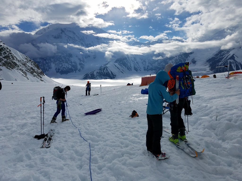 Gear check A climbing team does a final gear check before heading down glacier from Baescamp