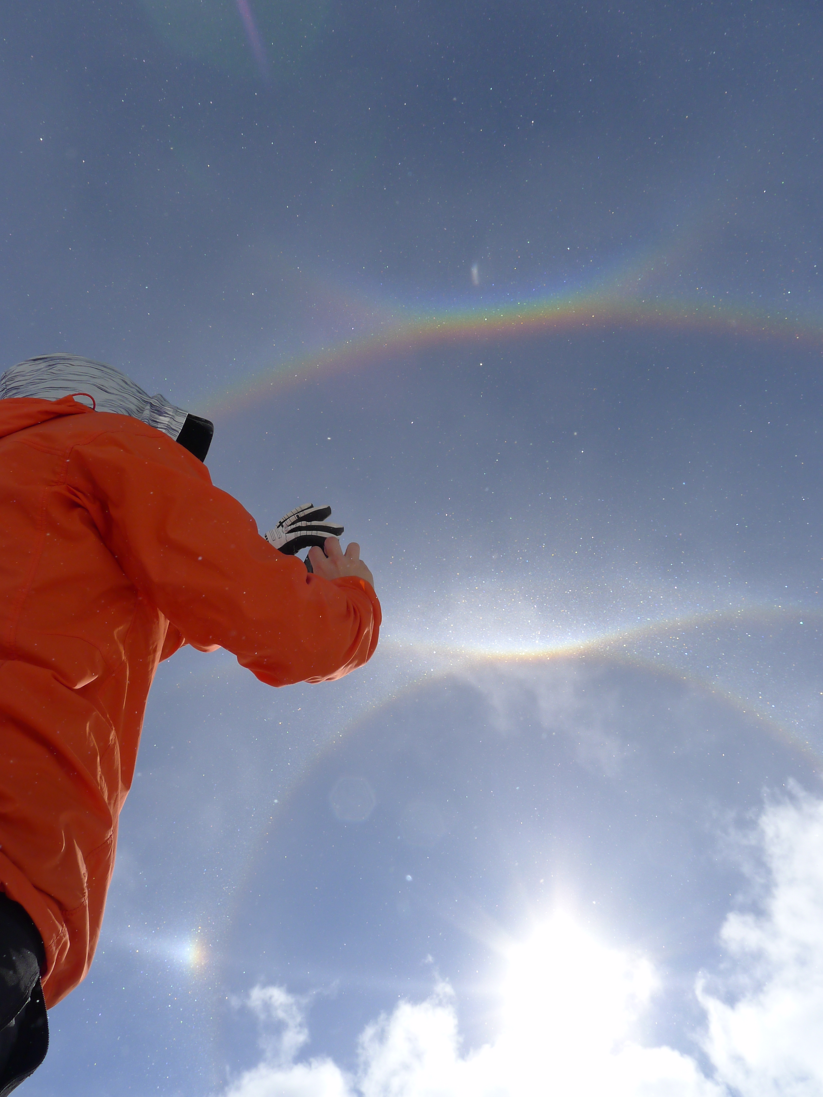 A volunteer ranger attempts to capture in the interlocking rainbows on camera