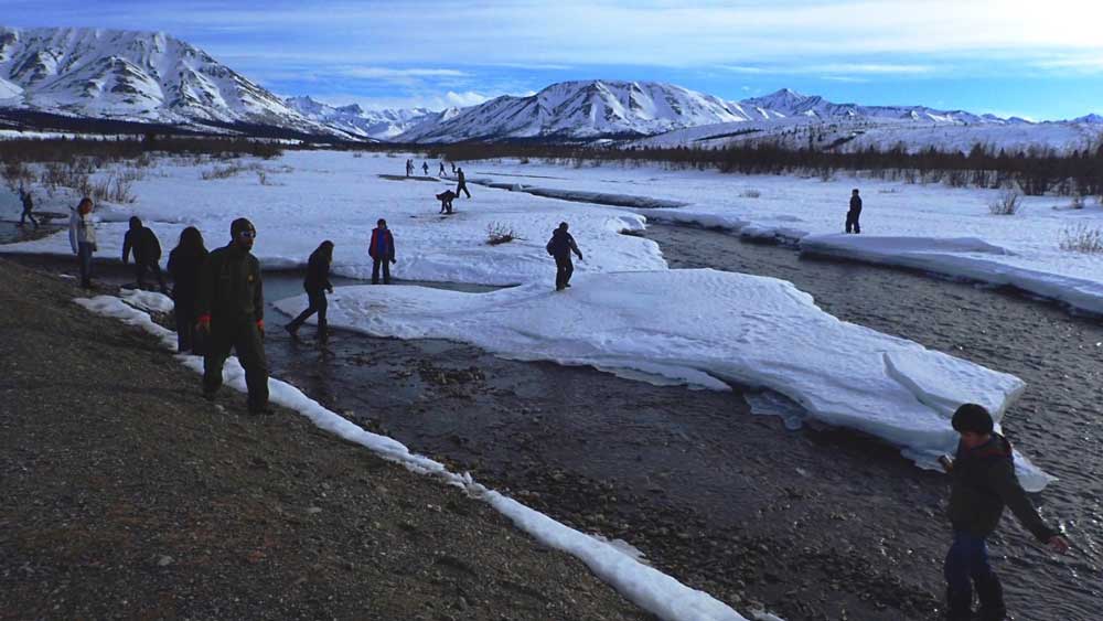 effie kokrine school teenagers exploring a shallow, partially frozen river