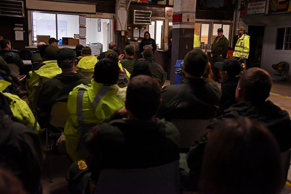 Park rangers meet inside to discuss safety and duties for upcoming flood