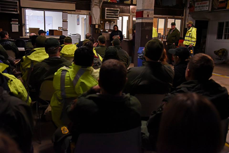 Flood Briefing Park rangers meet inside to discuss safety and duties for upcoming flood