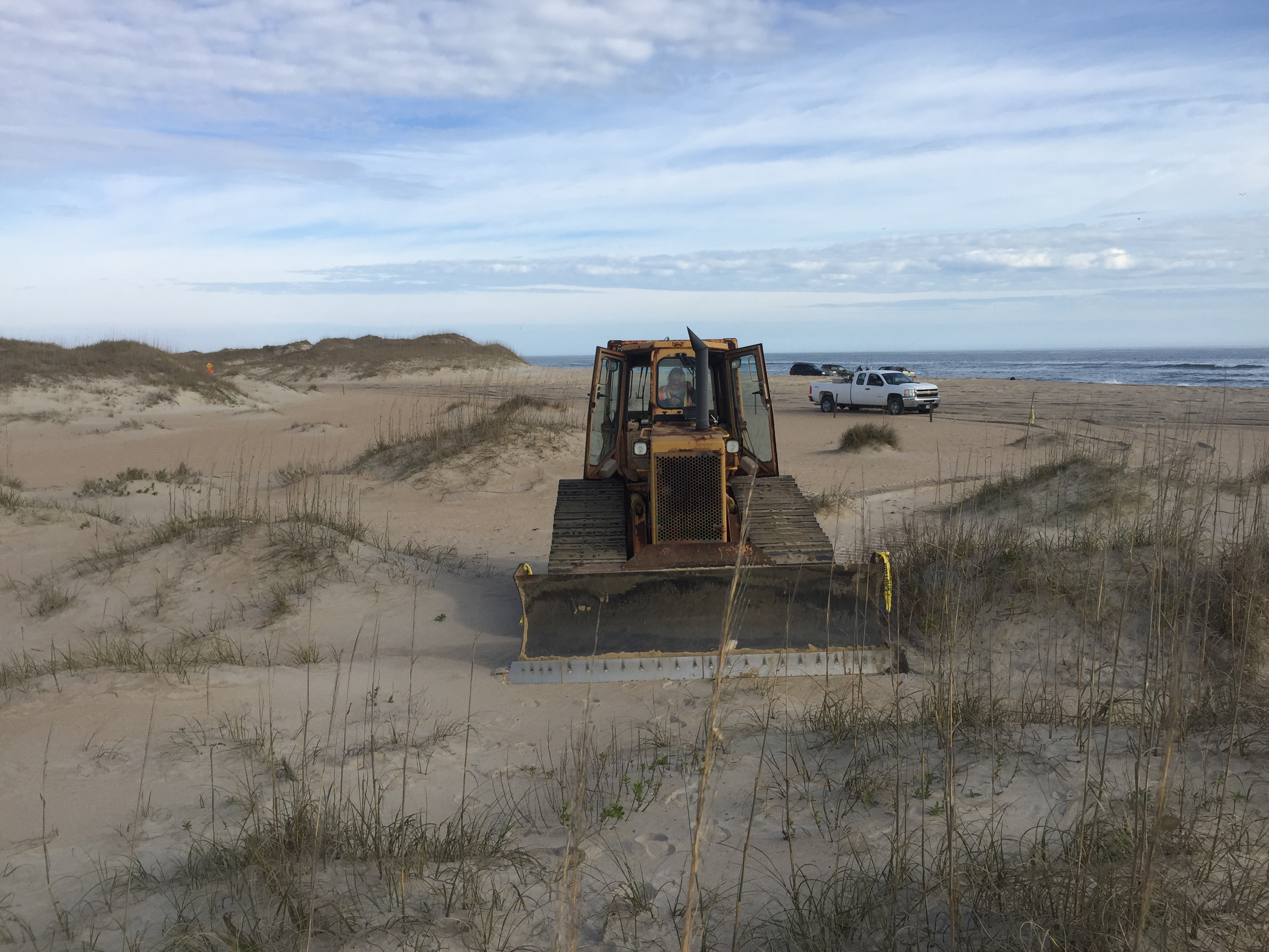 Cape Point bypass extension work started Bulldozer beginning work on Cape Point bypass extension. Park Ranger vehicle and Atlantic Ocean in background.