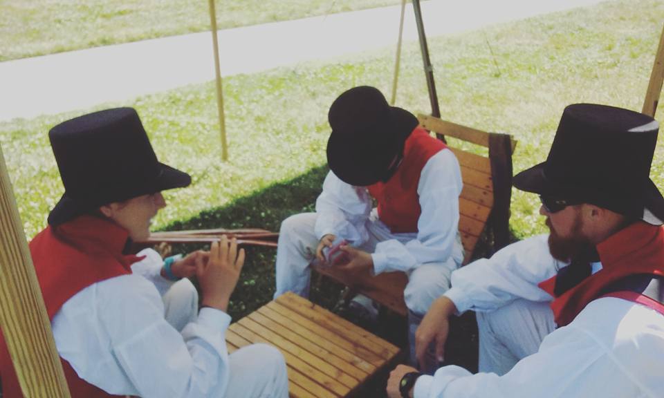 Sailors playing cards 3 sailors sitting around a small table playing cards under a canvas tarp