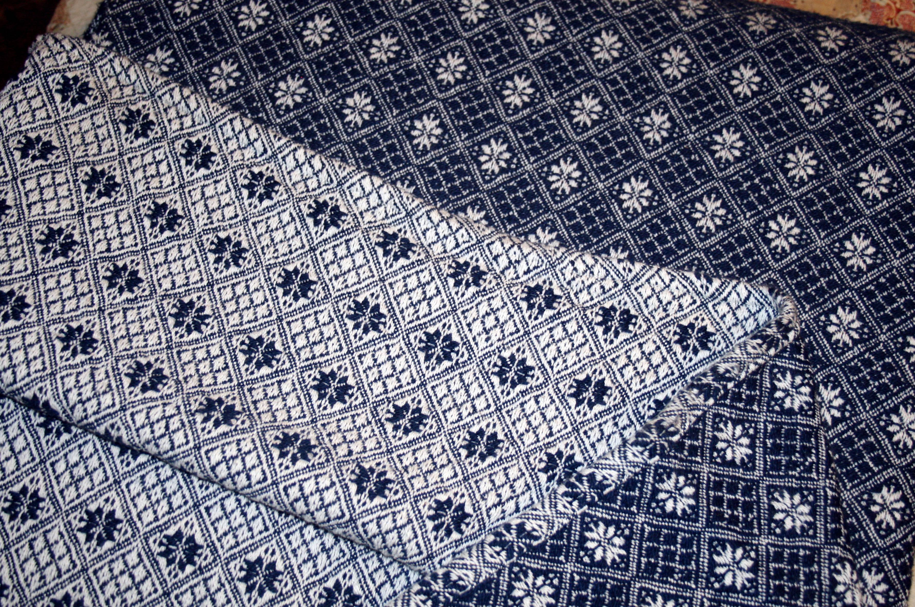 Woven Coverlet a woven coverlet in navy and white