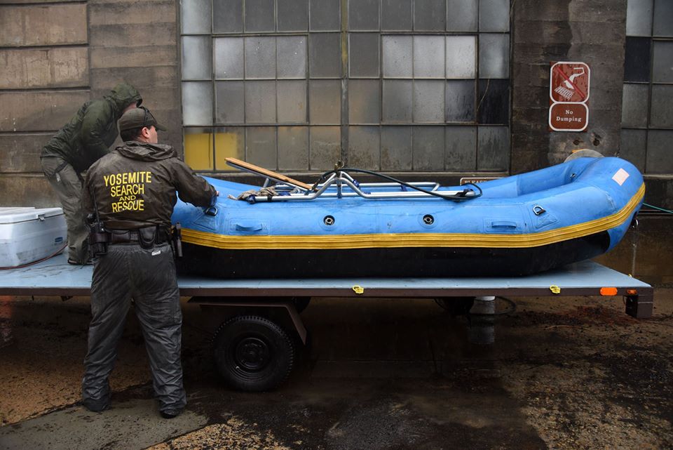 Park rangers prepare a rescue raft for possible use during flood