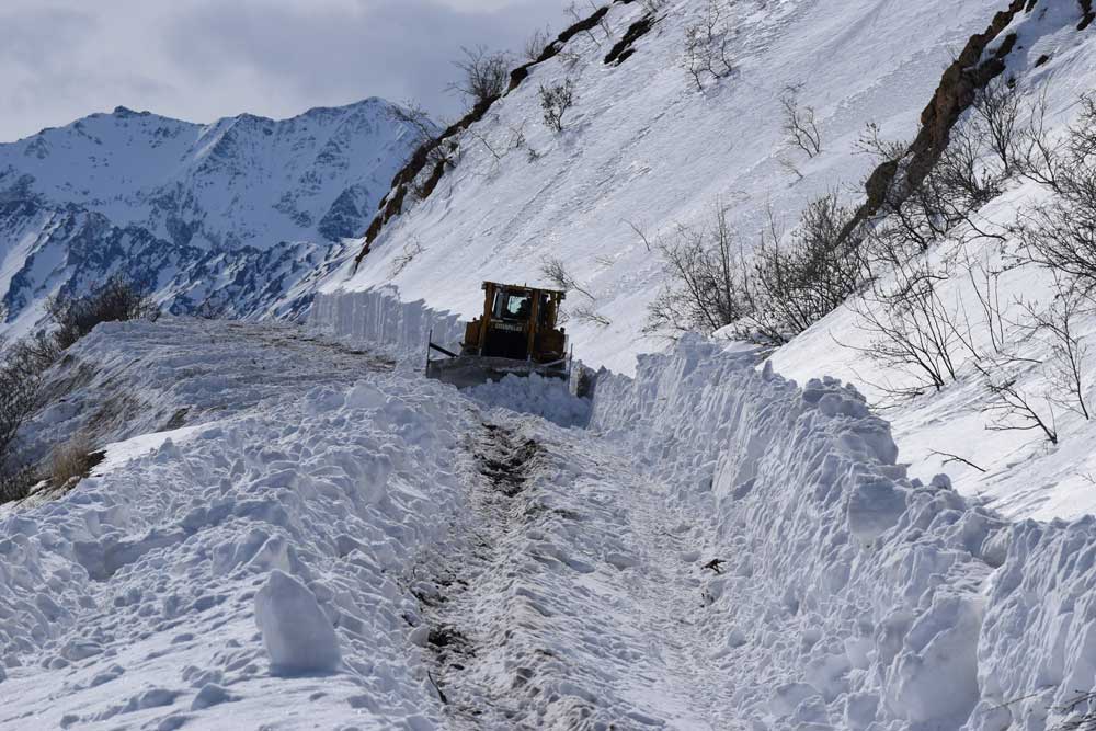 plowing up sable a machine plowing uphill through deep snow