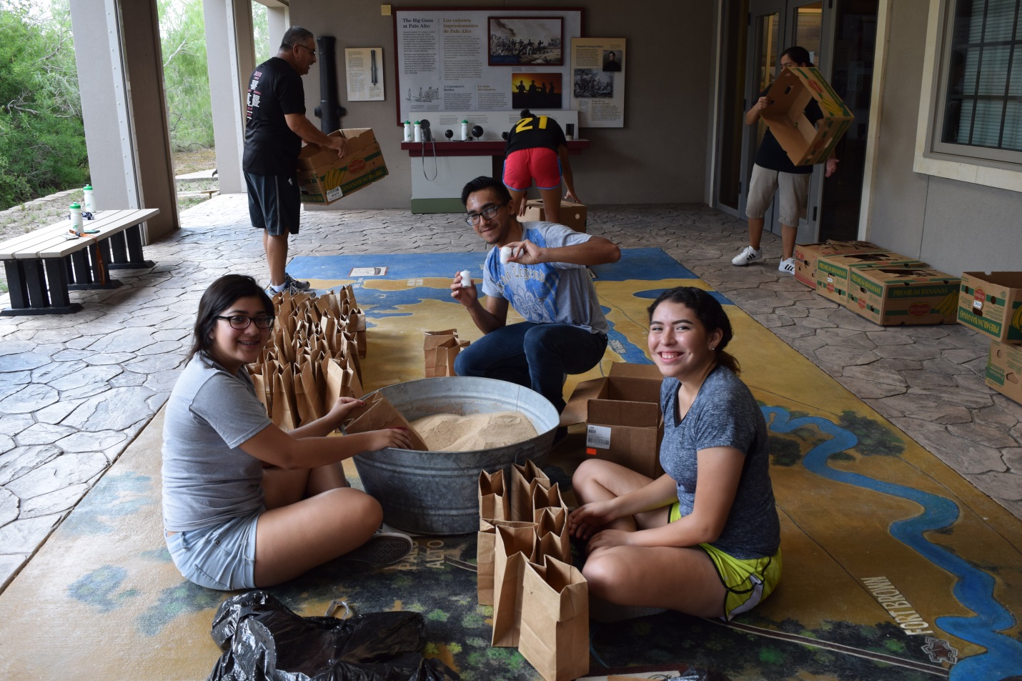 Volunteers preparing luminaries for memorial illumination event