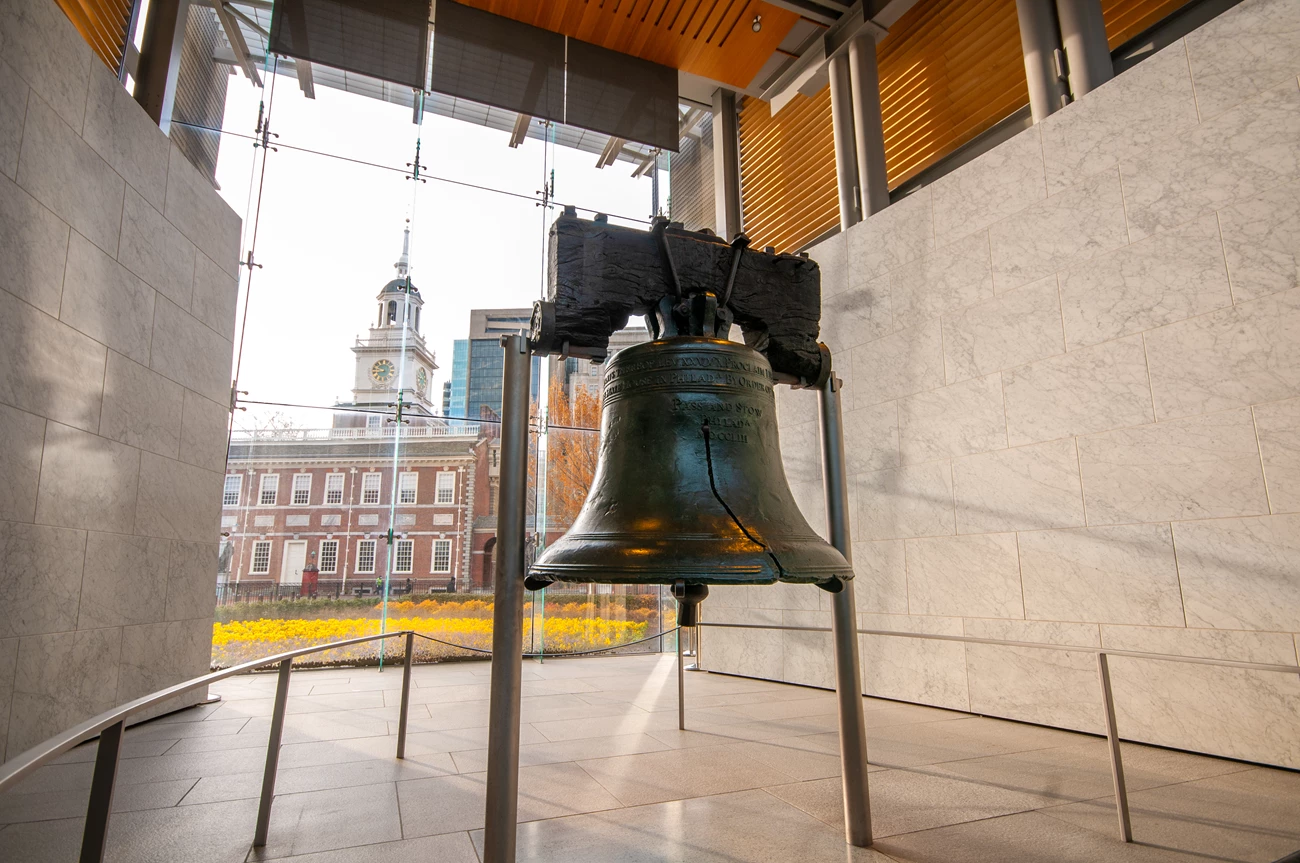 Liberty Bell Color photo showing the Liberty Bell with Independence Hall in the background.