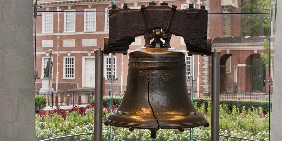 The Liberty Bell appears in the foreground with Independence Hall visible behind it. The Liberty Bell appears in the foreground with Independence Hall visible behind it.