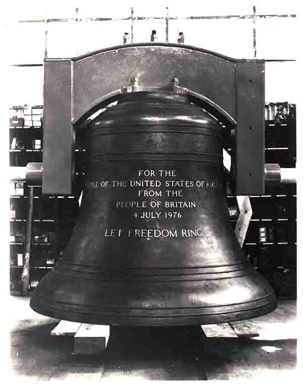 A black and white image of a large bell with dedication text "FOR THE PEOPLE OF THE UNITED STATES OF AMERICA FROM THE PEOPLE OF GREAT BRITAIN JULY 4, 1976 LET FREEDOM RING"