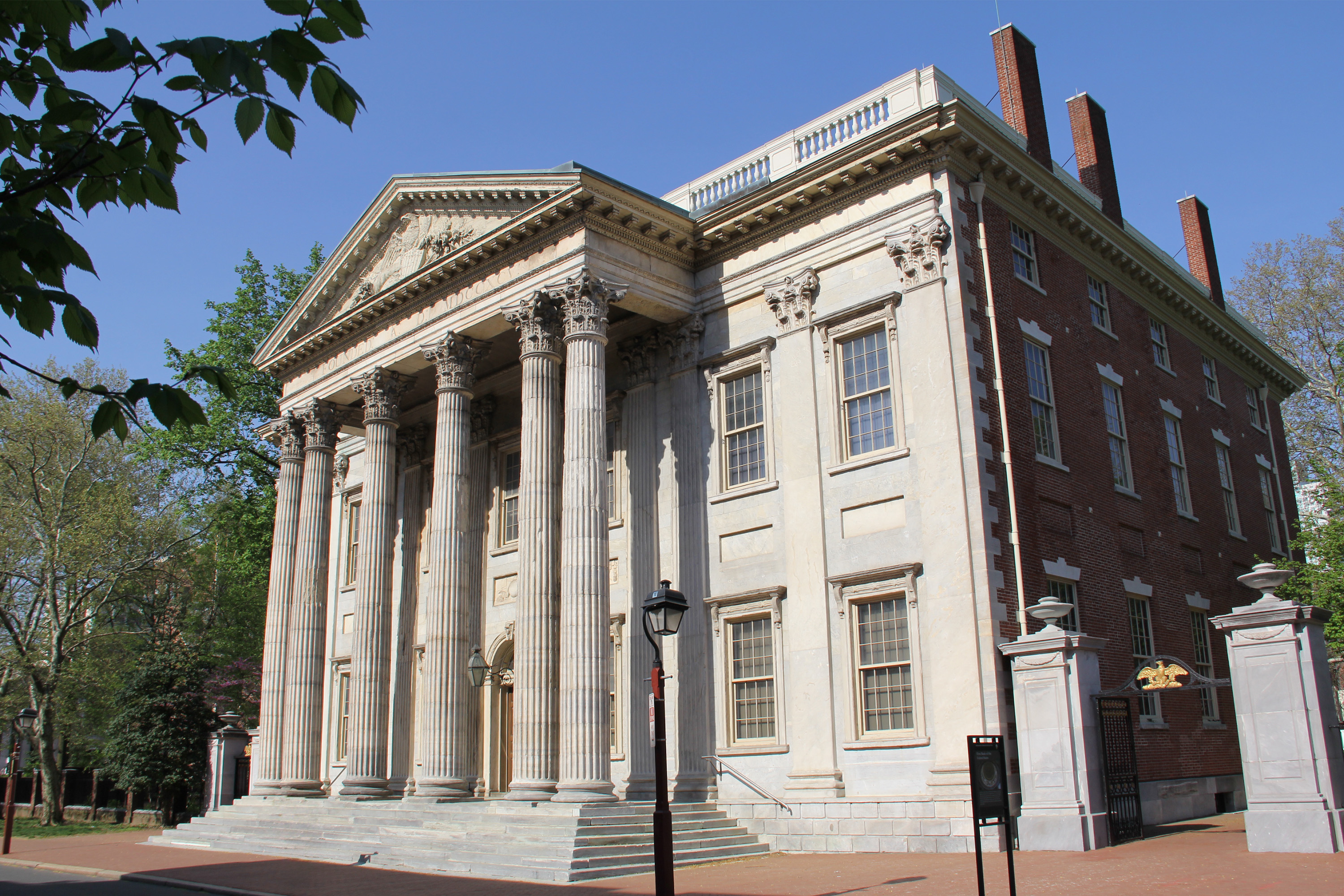 White marble two-story building with six columns