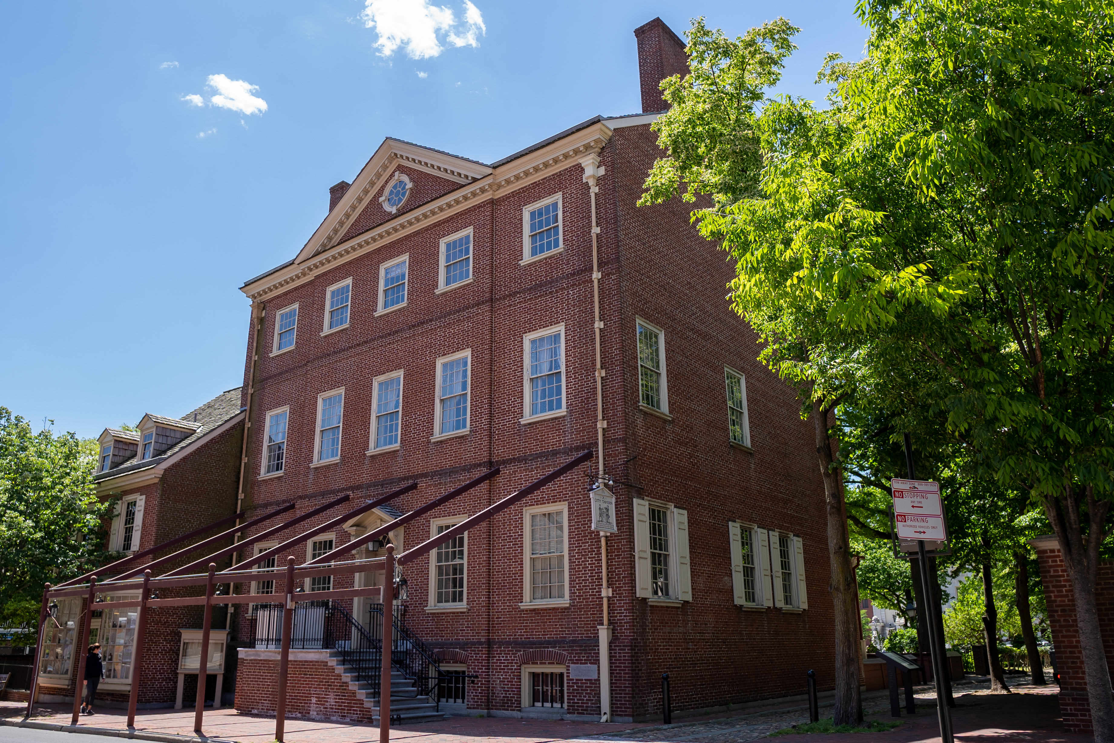 City Tavern A large brick colonial style building with wood frame for an awning.
