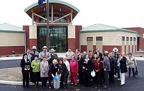 new building with group of people in front during a presentation