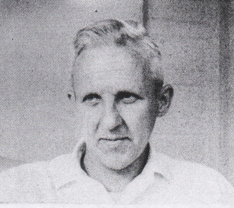 Photograph of a white-haired man staring just off-camera