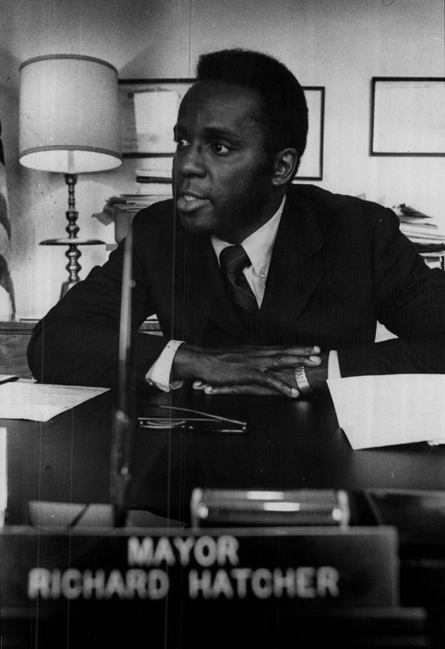 Mayor Hatcher Gary's Mayor Richard Gordon Hatcher seated at his desk with a plaque bearing his name.