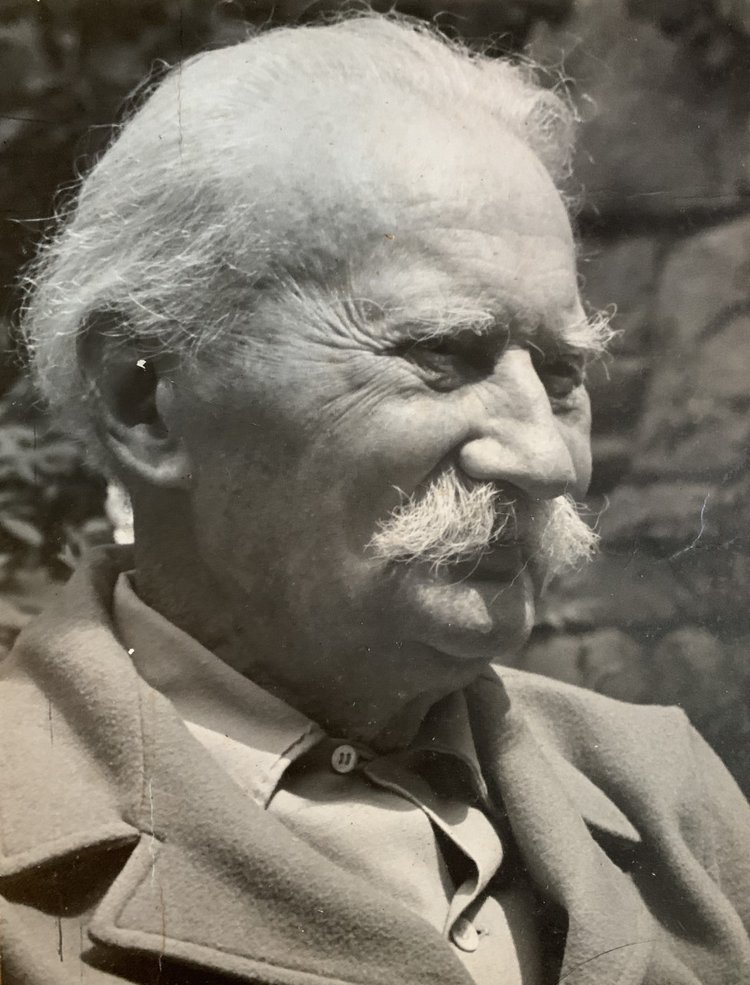 Close-up black and white photograph of a mature Jens Jensen sporting white hair and a large mustache
