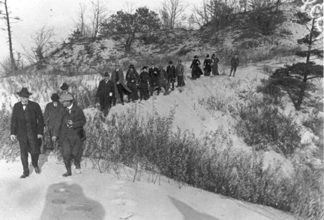 Mathers and the prairie club walking along the dunes.